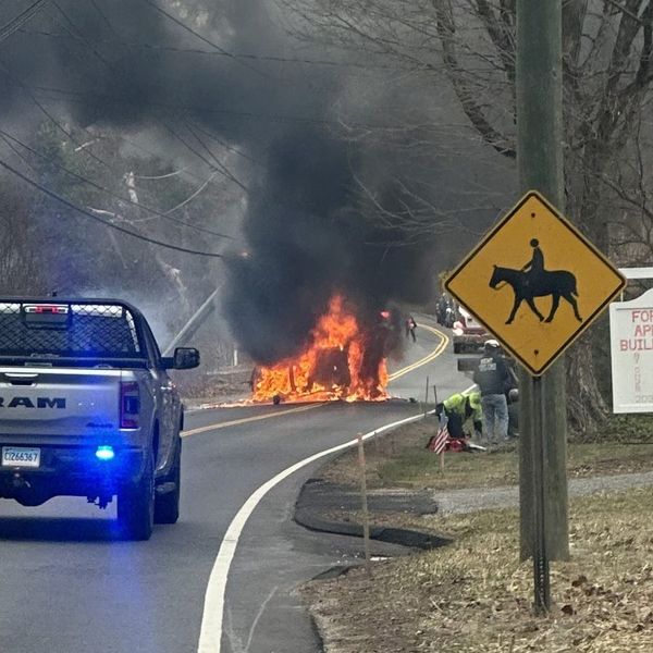 Neighbors pull woman from burning car with seconds to spare