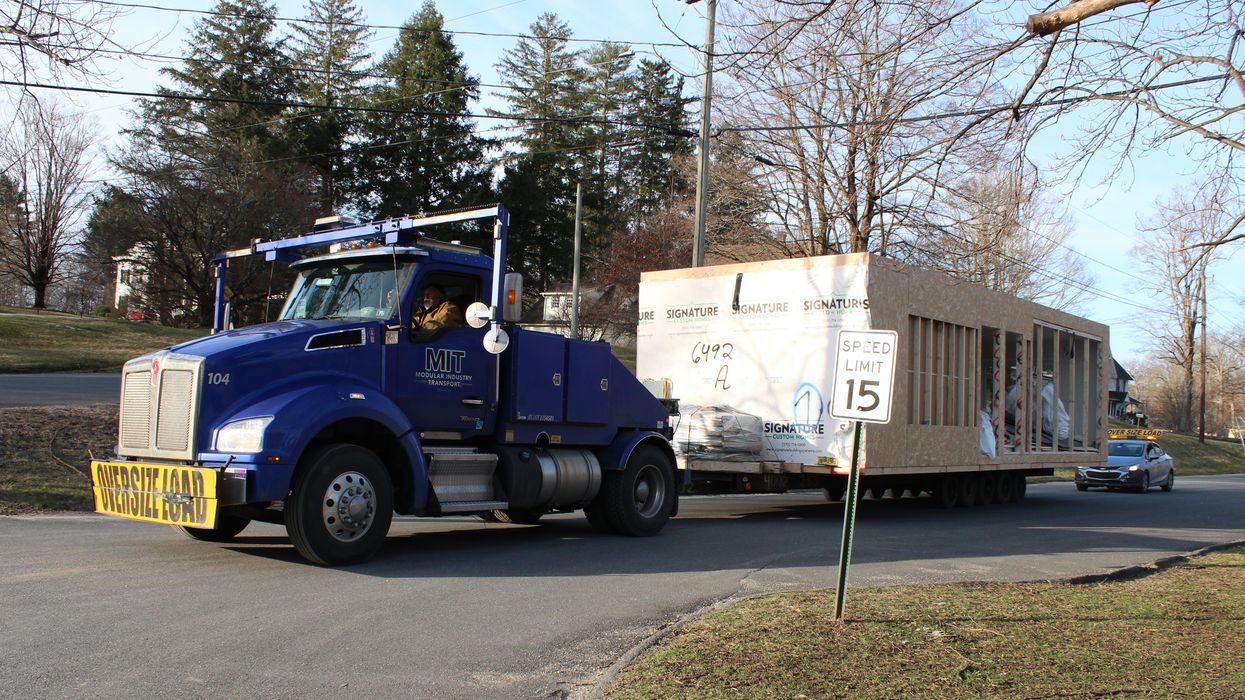 Future affordable homes arrive at Perry Street via semi-truck