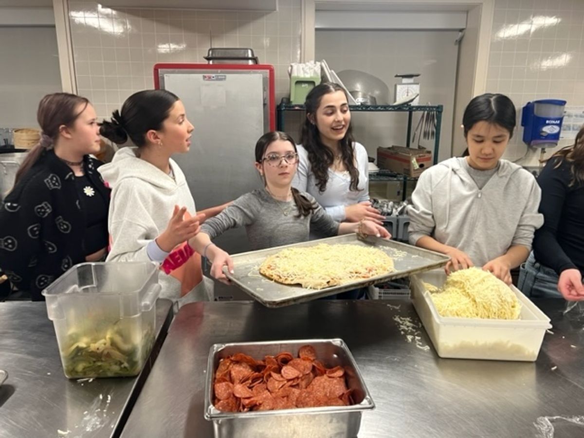 Students make 50 pizzas to feed local families