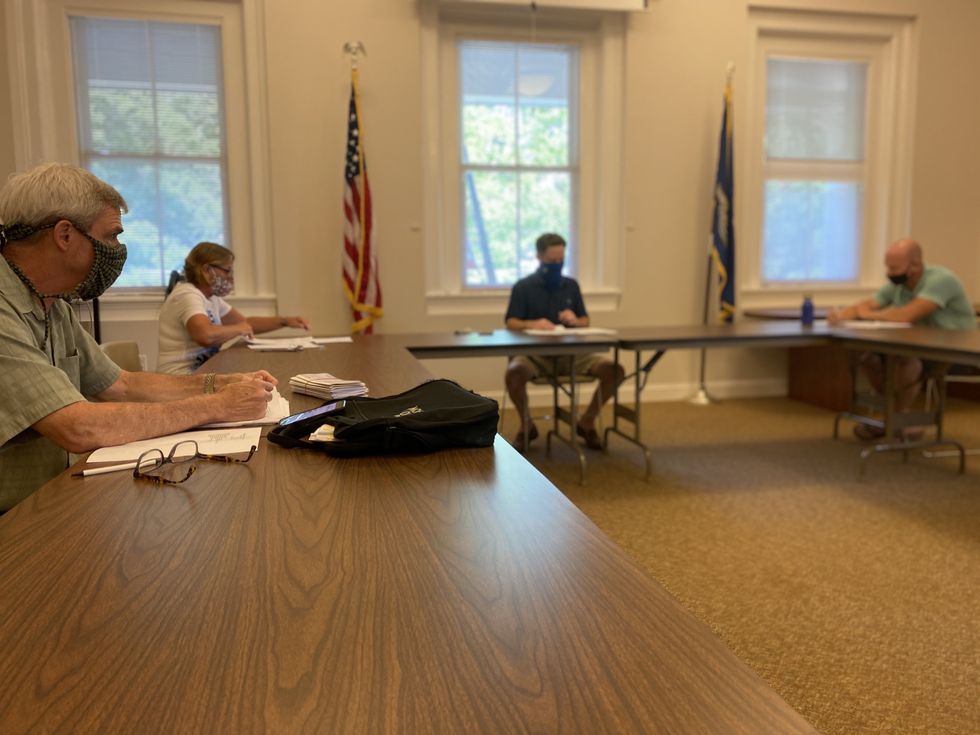 Safely behind a mask at a meeting